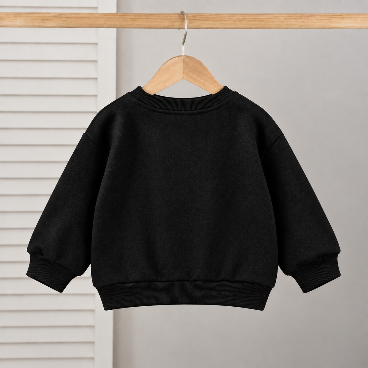 Stylish girls outfit with a modern touch - black top with stylish bowknot and attractive pleated jeans