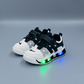 Kids LED light-up sneakers in four color options& with breathable mesh panels, hook-and-loop straps, and transparent soles that glow while walking.