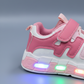 Kids LED light-up sneakers in four color options& with breathable mesh panels, hook-and-loop straps, and transparent soles that glow while walking.
