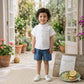 Stylish kids' outfit with a modern design, featuring a button-up shirt and denim shorts – perfect for a comfortable and coordinated look on sunny days!