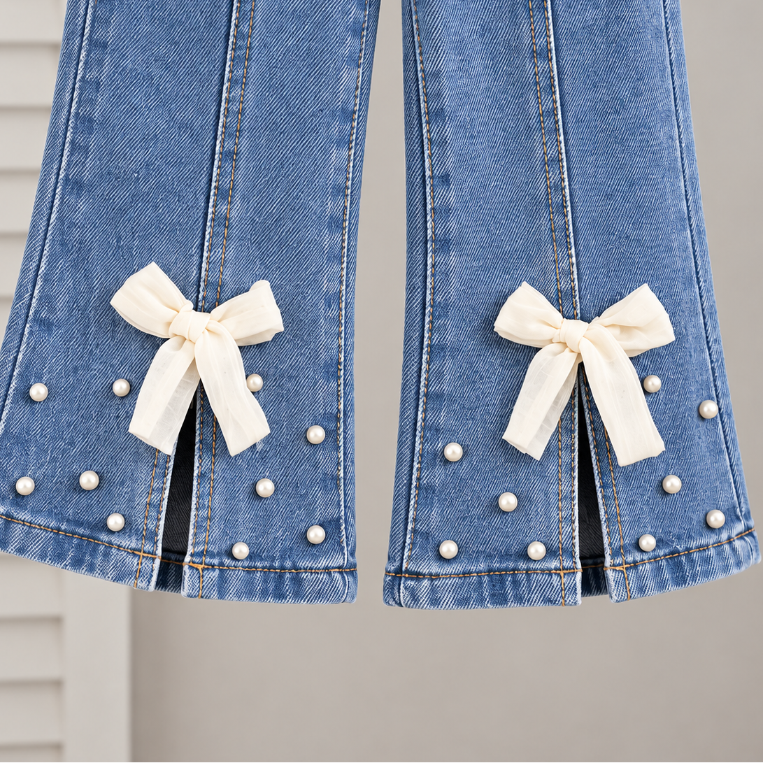 Stylish girls outfit with a modern touch - black top with stylish bowknot and attractive pleated jeans
